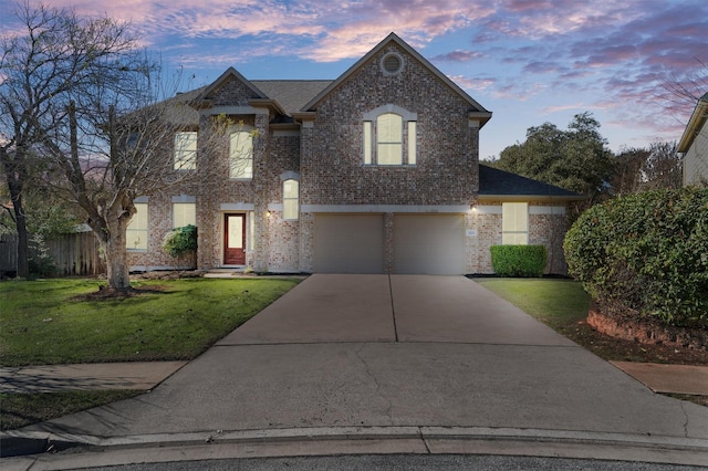 view of front of house featuring a garage and a lawn