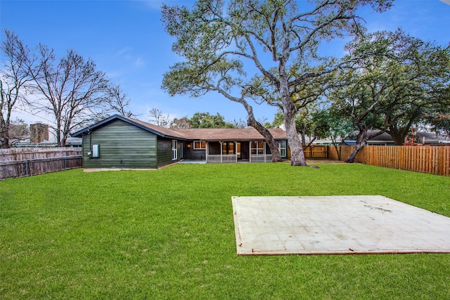 rear view of house with a yard and a patio