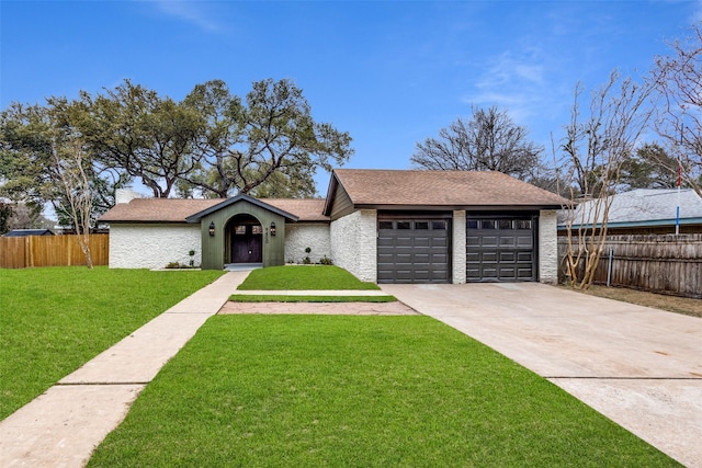 single story home featuring a garage and a front lawn