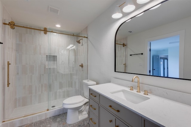 bathroom featuring vanity, toilet, and walk in shower