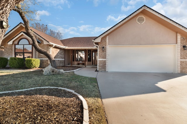 single story home featuring a front lawn and a garage