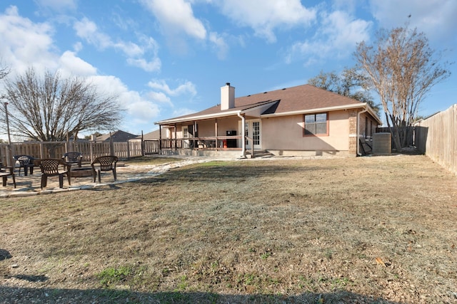 rear view of house with a yard, a patio, and central air condition unit