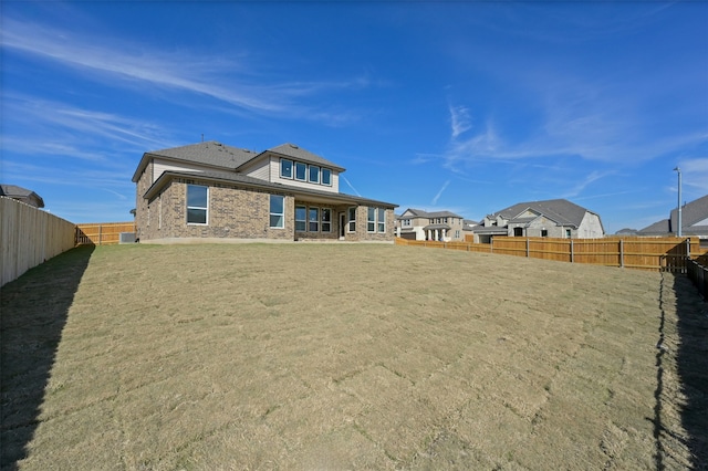 back of house featuring a yard