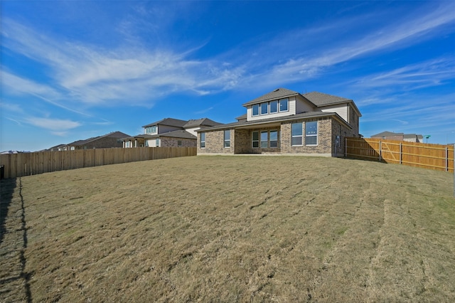 rear view of house with a lawn