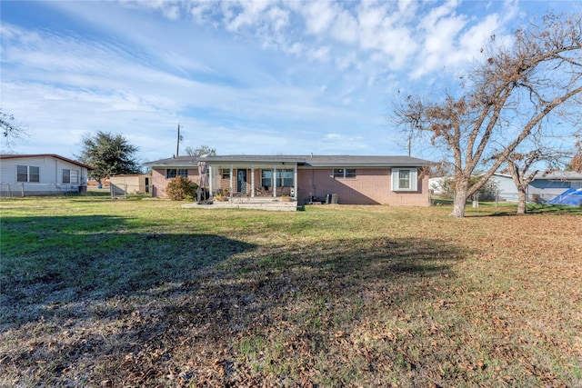 rear view of property with a yard