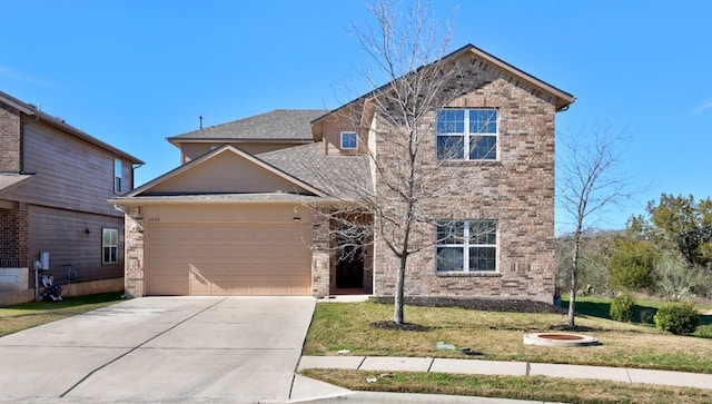 view of property featuring a garage and a front yard