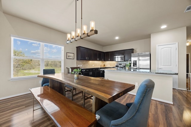 dining space featuring dark hardwood / wood-style flooring and a notable chandelier