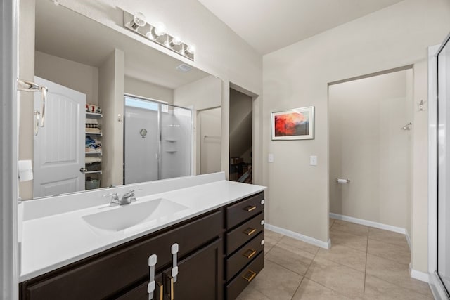 bathroom featuring vanity, an enclosed shower, and tile patterned floors