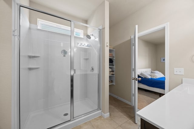 bathroom featuring walk in shower, tile patterned floors, and vanity