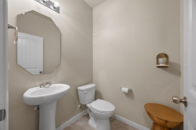 bathroom with tile patterned floors, toilet, and sink