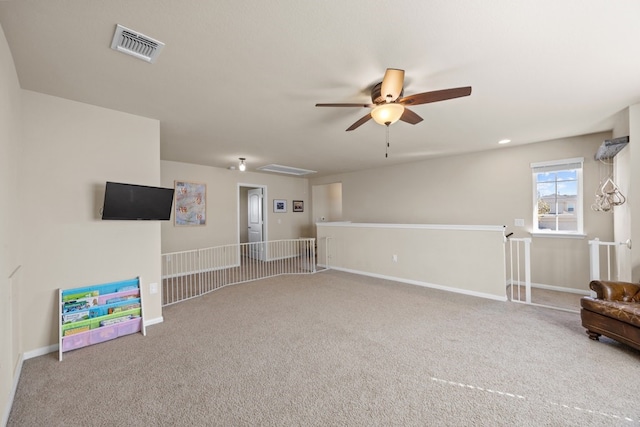 interior space with carpet floors and ceiling fan