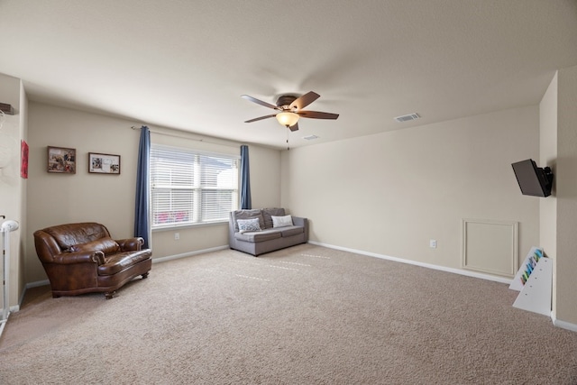 living area featuring ceiling fan and carpet floors