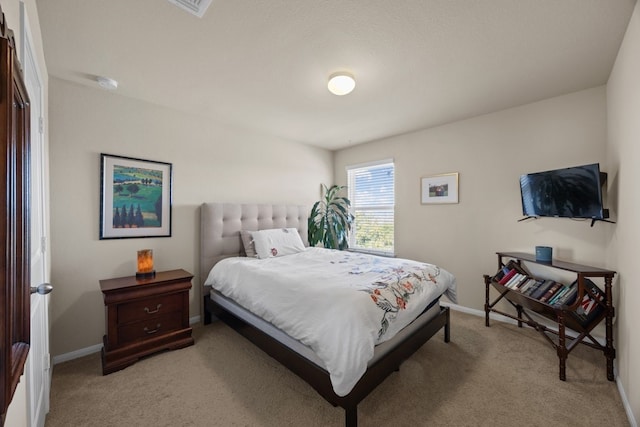 bedroom featuring light carpet