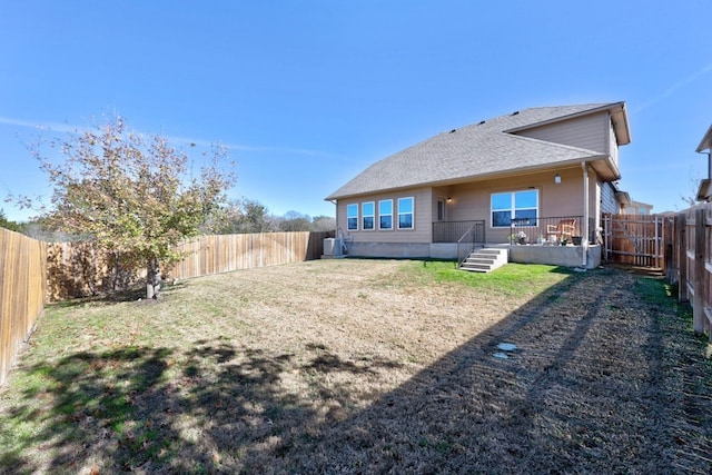 back of property featuring a yard and central air condition unit