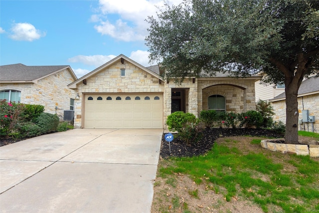 view of front of property with a garage and central AC unit