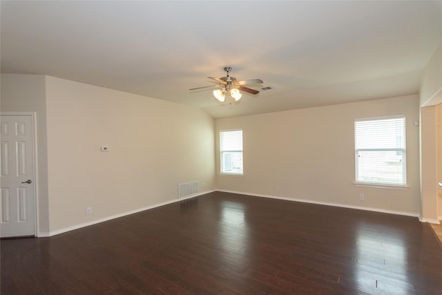 unfurnished room with vaulted ceiling, ceiling fan, and dark wood-type flooring