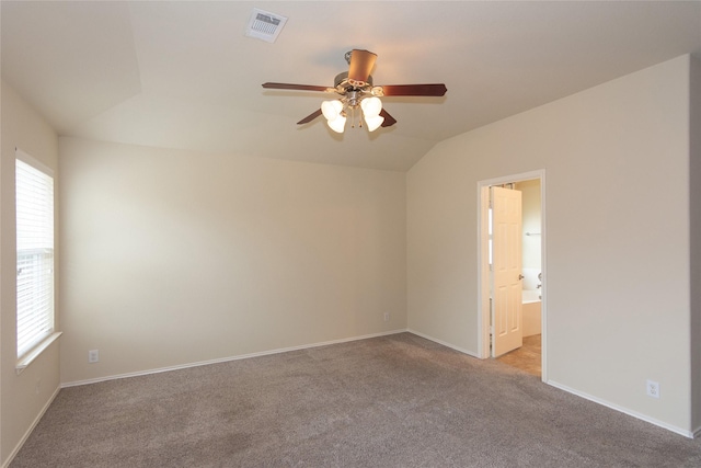 empty room featuring ceiling fan, light colored carpet, and lofted ceiling