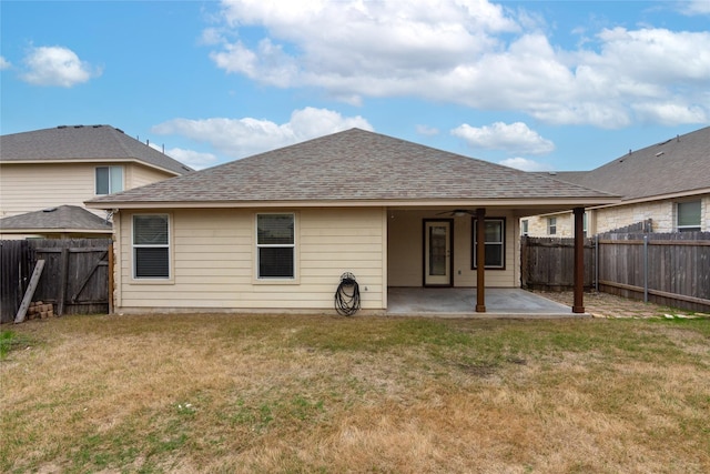 back of property featuring a yard, ceiling fan, and a patio area