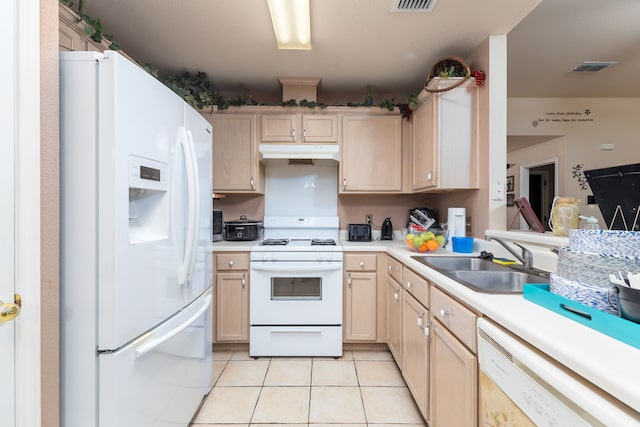 kitchen with light brown cabinetry, white appliances, light tile patterned floors, and sink