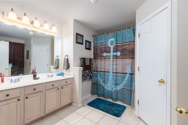 bathroom featuring tile patterned flooring, vanity, and walk in shower