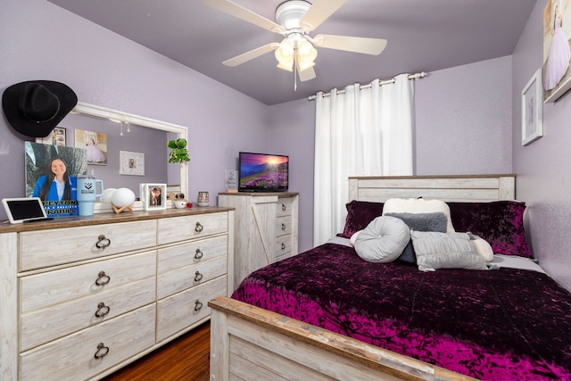 bedroom featuring ceiling fan and dark wood-type flooring