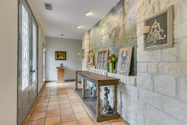 entryway with tile patterned flooring and french doors