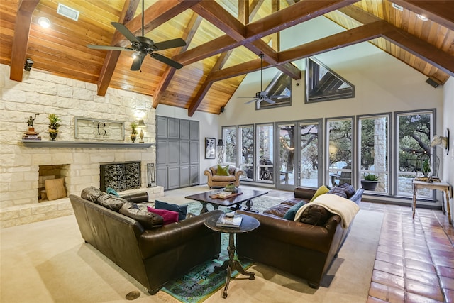 tiled living room featuring beam ceiling, wooden ceiling, high vaulted ceiling, and a stone fireplace