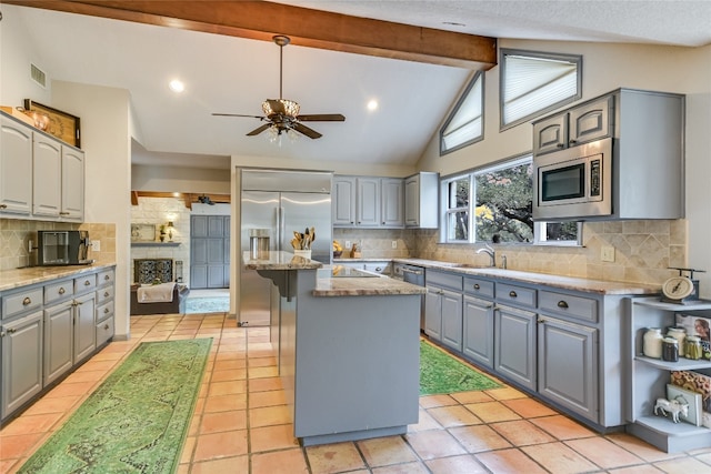 222 Winn Valley Dr, Wimberley, TX 78676 - kitchen with gray cabinetry, built in appliances, a kitchen island, decorative backsplash, and recessed lighting