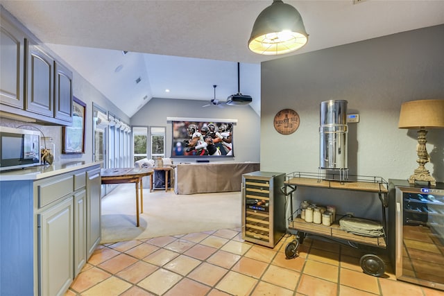 kitchen with light carpet, vaulted ceiling, ceiling fan, and beverage cooler