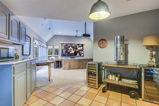 222 Winn Valley Dr, Wimberley, TX 78676 - kitchen featuring beverage cooler, lofted ceiling, ceiling fan, light carpet, and light tile patterned flooring