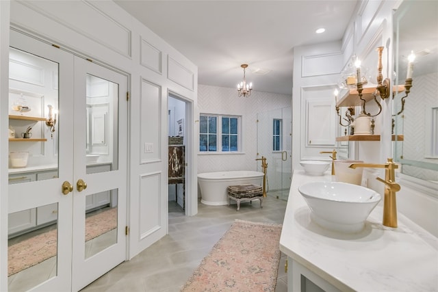 222 Winn Valley Dr, Wimberley, TX 78676 - bathroom featuring a shower stall, a chandelier, vanity, and a soaking tub