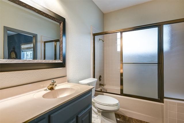 222 Winn Valley Dr, Wimberley, TX 78676 - bathroom with plenty of natural light, toilet, bath / shower combo with glass door, vanity, and a textured wall