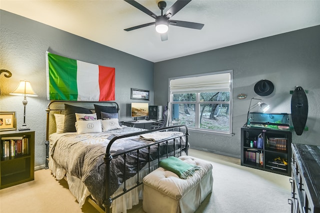 bedroom featuring light carpet and ceiling fan