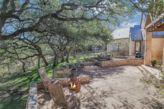 view of patio / terrace with a shed