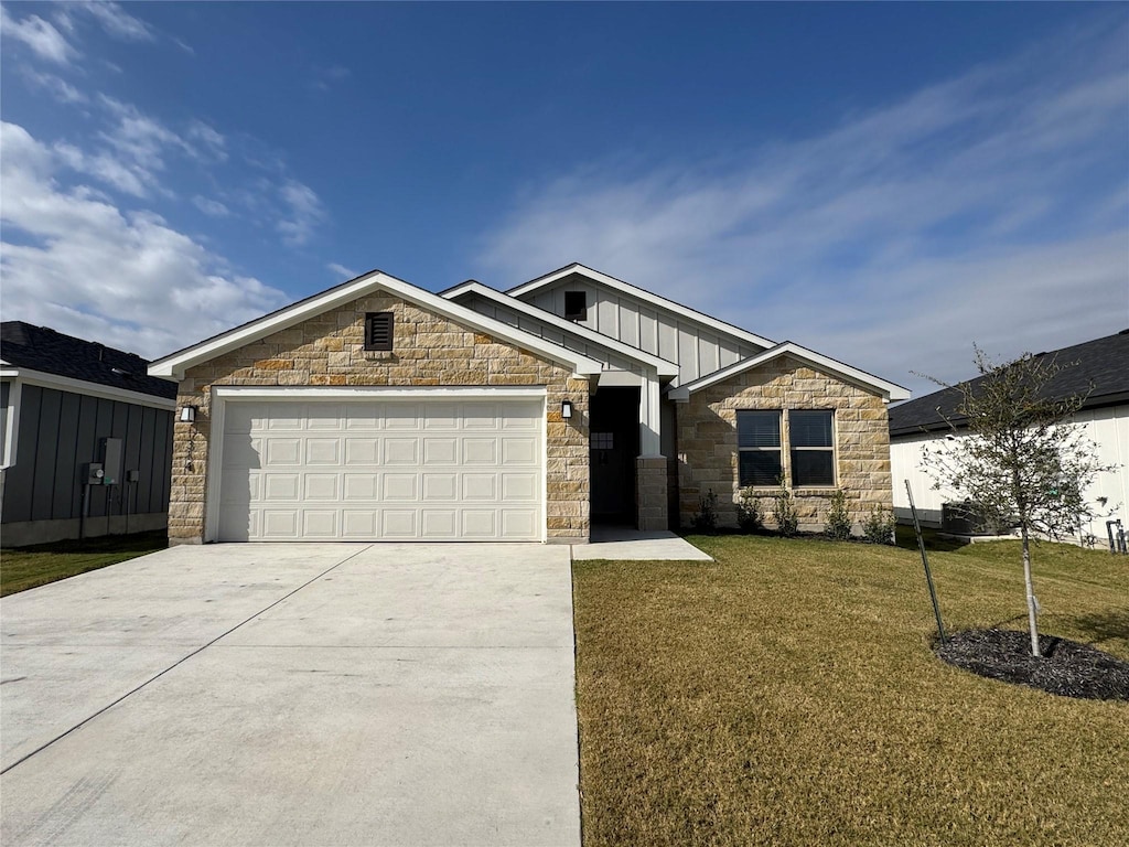 craftsman-style house featuring a front yard and a garage