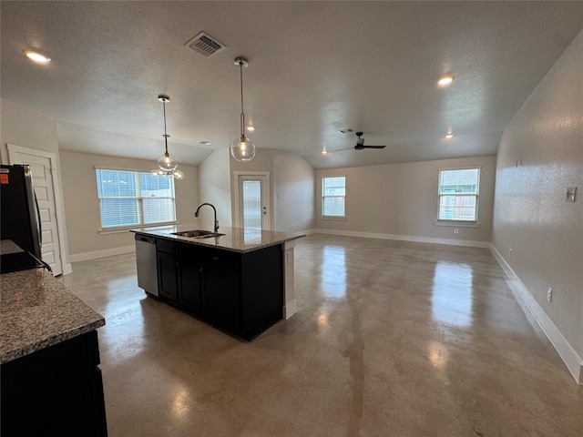 kitchen featuring light stone counters, stainless steel appliances, ceiling fan, sink, and decorative light fixtures