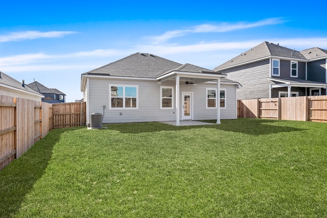 back of house with central AC unit, ceiling fan, a yard, and a patio