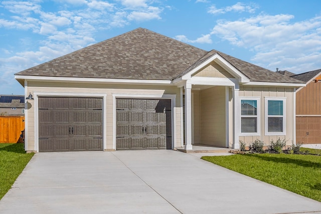 ranch-style home featuring a front yard and a garage