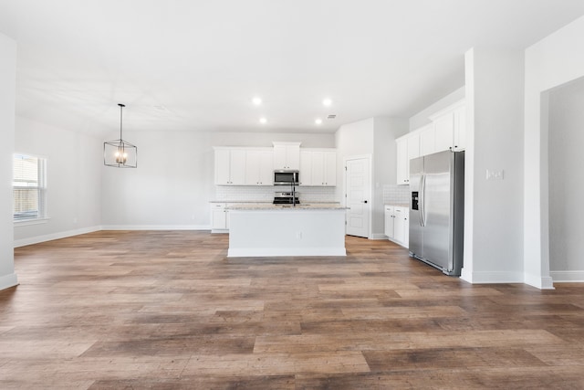 kitchen featuring a center island with sink, white cabinets, light hardwood / wood-style floors, and appliances with stainless steel finishes