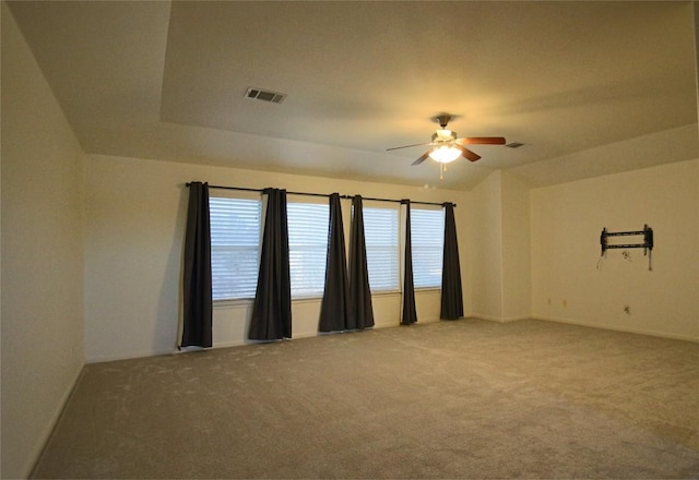 spare room featuring ceiling fan and carpet