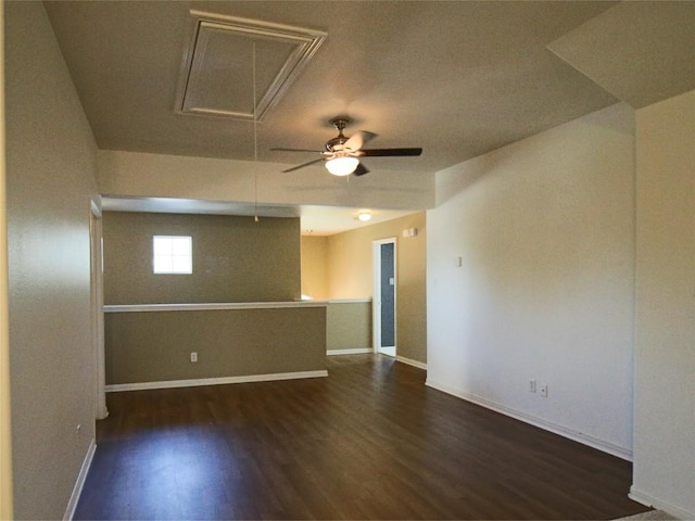 spare room with dark wood-type flooring and ceiling fan