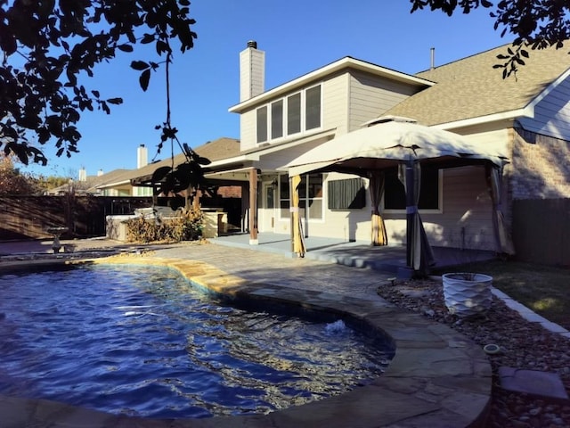 back of house featuring a bar and a patio