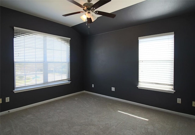 carpeted spare room featuring ceiling fan and lofted ceiling