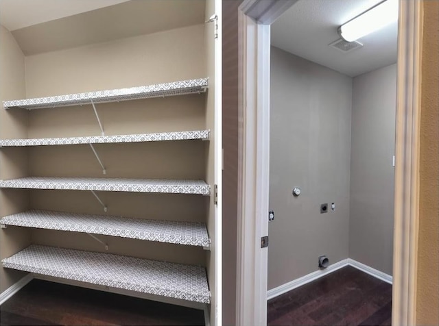 laundry area featuring dark hardwood / wood-style floors and hookup for an electric dryer