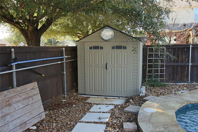 view of outbuilding with a fenced in pool