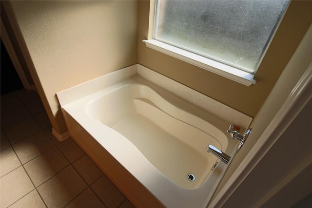 bathroom featuring tile patterned floors and a tub