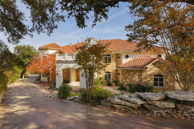 mediterranean / spanish home with a garage