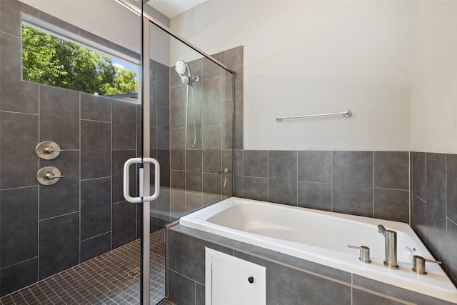 full bath featuring a stall shower and a garden tub