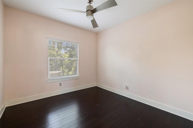 unfurnished room with a ceiling fan, dark wood-style flooring, and baseboards