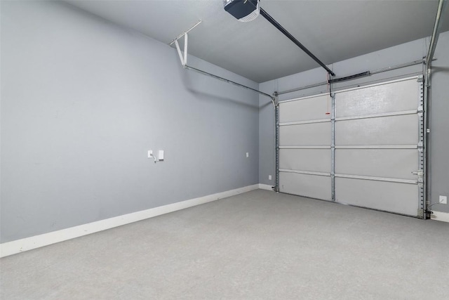 garage with baseboards and a garage door opener